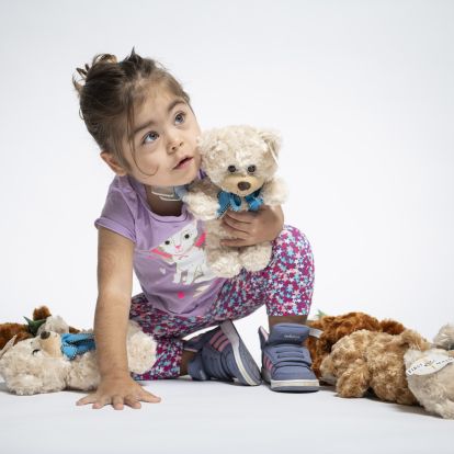 image of child with teddy bears