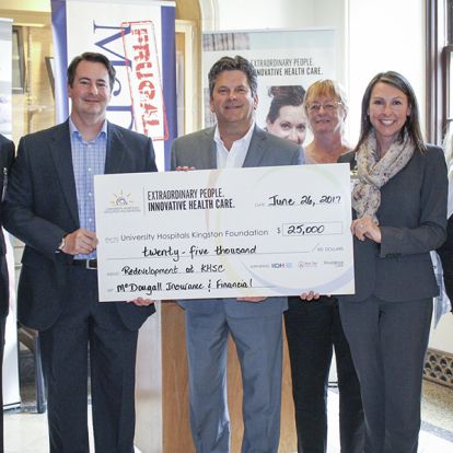 KHSC Board Chair David O'Toole (left) and UHKF staff (right) accept a donation from MacDougall Insurance and Finance (centre)