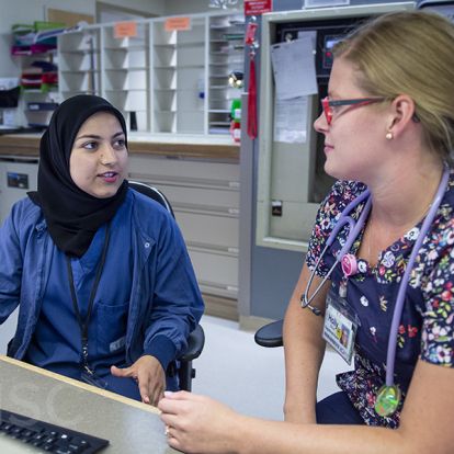 Registered nurse Holly Stroud and first-year resident Dr. Hossai Furmli on Kidd 5 Obstetrics and Gynecology discuss the CBME online evaluation portal