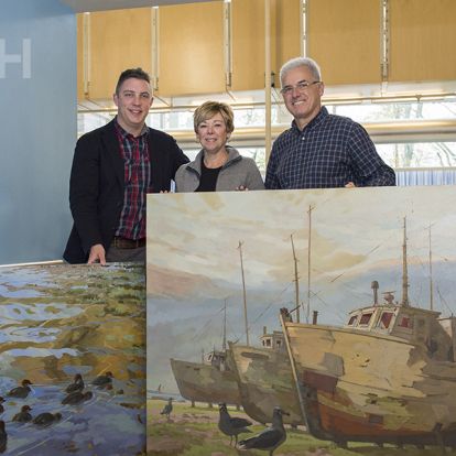 (Left) Tyler Hands, Program Manager of Inpatient and Ambulatory Oncology, thanks artist Robert Shackles and his wife Sylvia for their two big donations to our art collection.